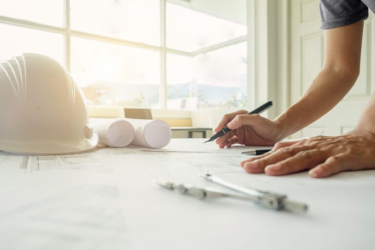 Hands of Engineer working on blueprint,Construction concept