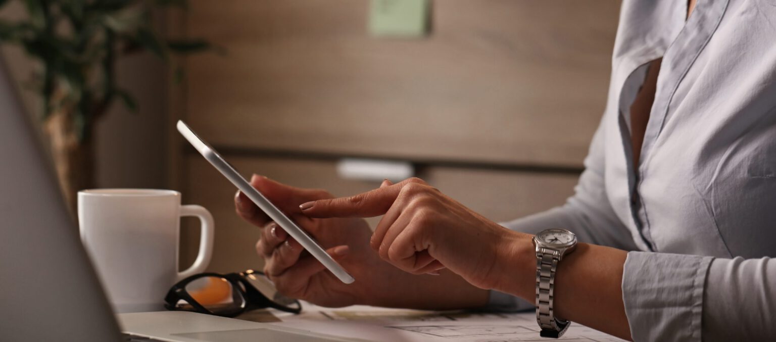 Young entrepreneur using electronic organizer while working in the office
