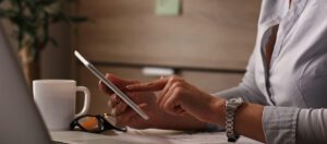 Young entrepreneur using electronic organizer while working in the office