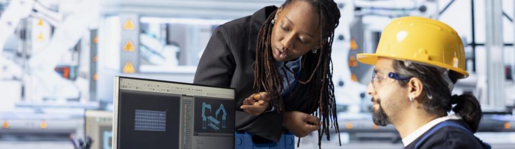 Man and woman working in photovoltaics factory optimizing production flow