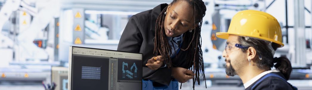 Man and woman working in photovoltaics factory optimizing production flow
