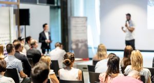 Male business speaker giving a talk at business conference event