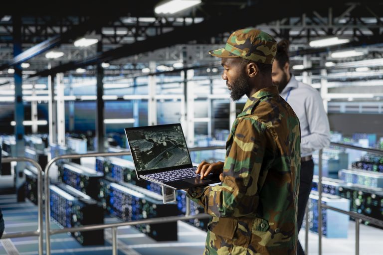 Black army technology specialist troubleshooting military pc systems